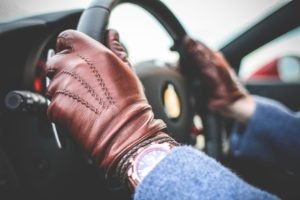 Wearing driving gloves, driving a car